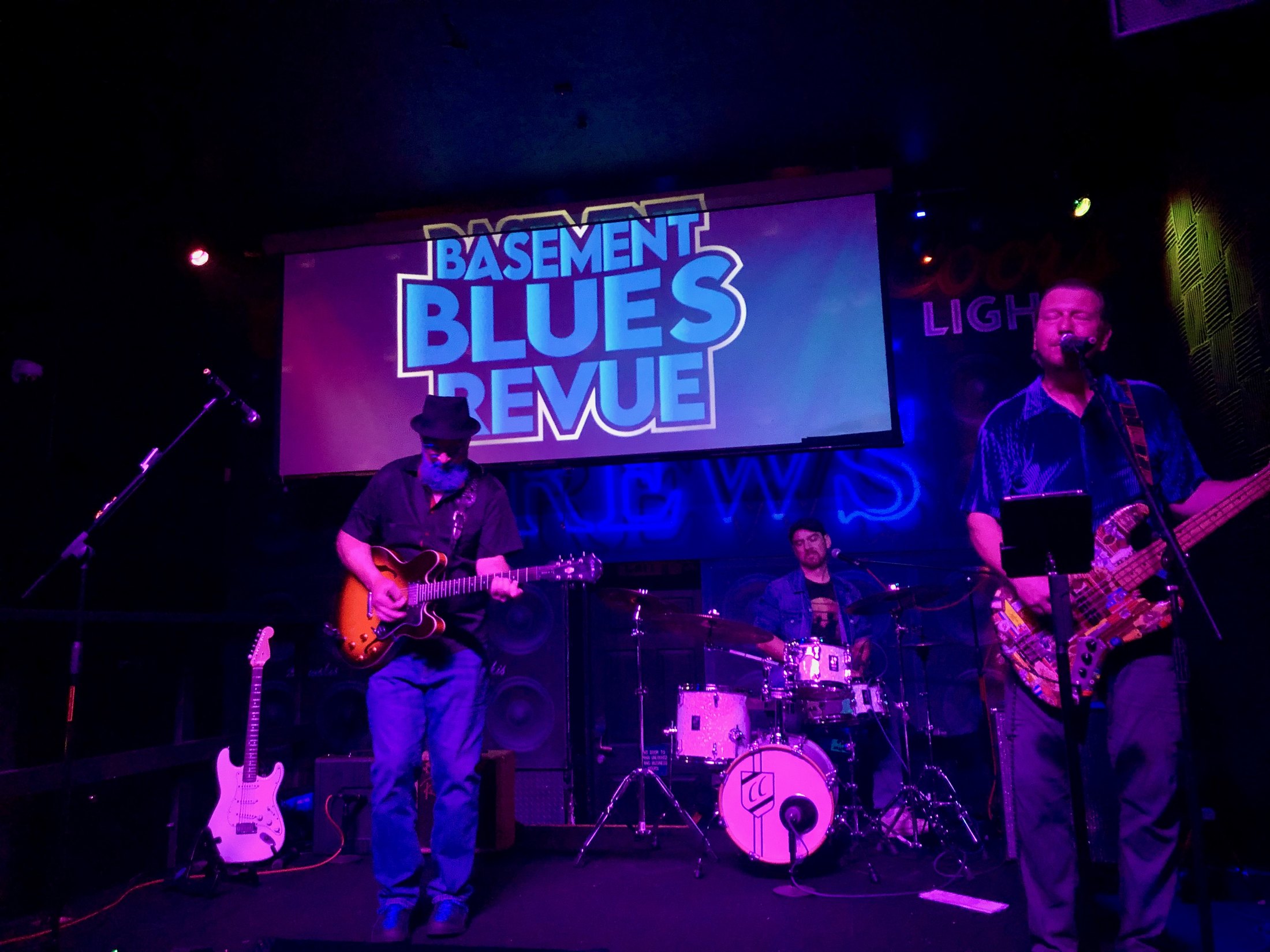 Basement Blues Revue performing live beneath the band's name